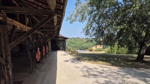 A rustic wooden building with a gravel path leading to a covered area. - Charming old house with private SPA and swimming pool, estate in nature park (Les Pechs Du Vers)