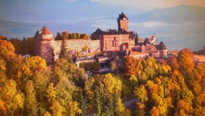 A historic castle surrounded by autumn foliage.