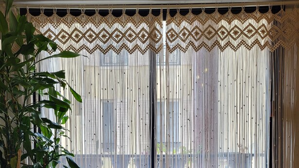A room with a sofa, a decorative macrame curtain, a potted plant, and a wooden floor. - Excellent Apartment totally renovated, Paris 5th arrondissement (Paris)