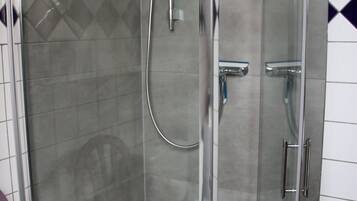 Shower, hair dryer, soap, toilet paper