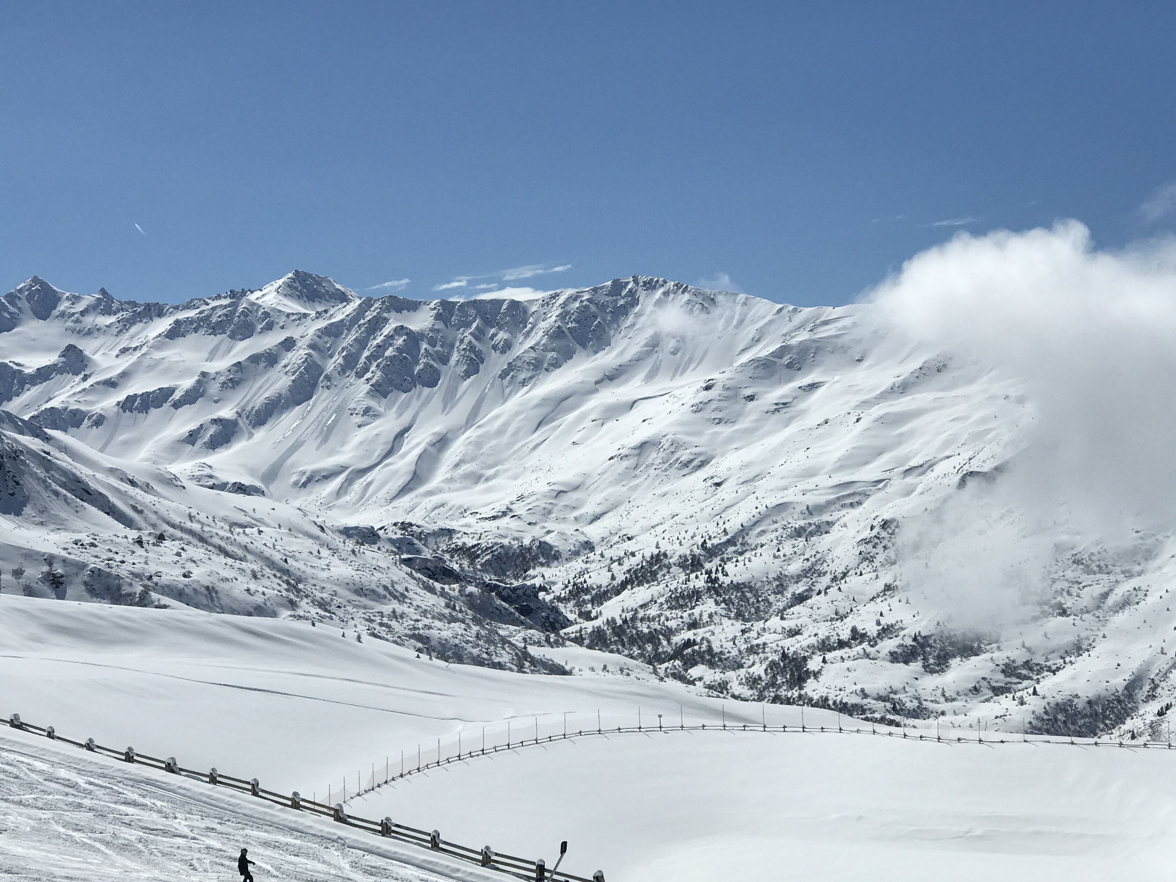 A snow-covered mountain landscape with a clear sky.