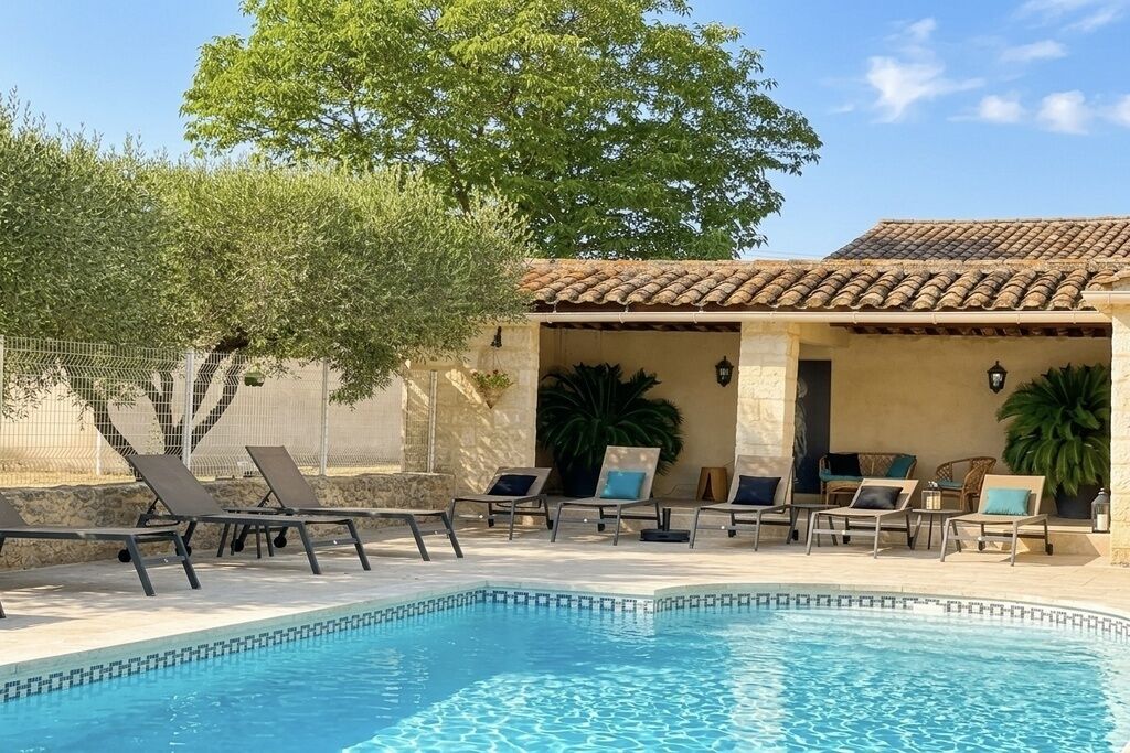 A pool area with lounge chairs and a pergola.