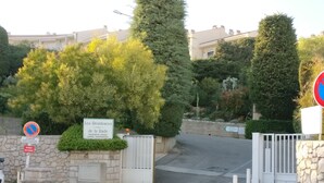 A gated entrance with a sign indicating private property and a no parking sign.