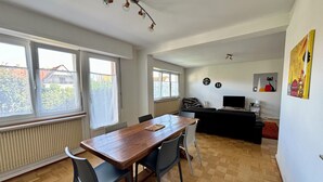 A modern living space with a dining area, kitchen, and seating area. - 3 Storks, House 9 acres, Alsace Centre (Châtenois)
