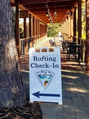 Relax by the river at our rafting check-in point, where you can unwind with a seat at one of our tables.