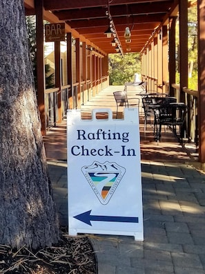 Relax by the river at our rafting check-in point, where you can unwind with a seat at one of our tables.