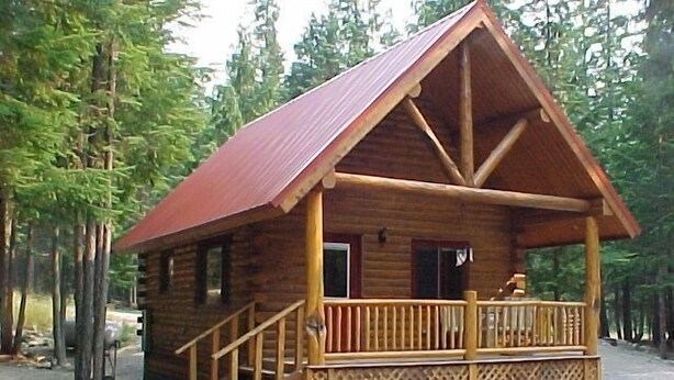 A wooden cabin with a porch and stairs leading to the entrance. - Sha Bear Cabin, on the YAAK RIVER~Quiet, Romantic Cabin Sleeps up to 4 (Troy)