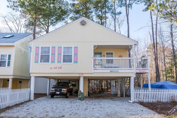 A two-story house with a covered front porch, a garage, and a driveway. - Comfortable Beach Cottage, just 1 mile to Bethany Beach! Community Pool, Tennis, Beaches! (Frankford)
