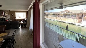 A balcony with a view of a swimming pool and houses.