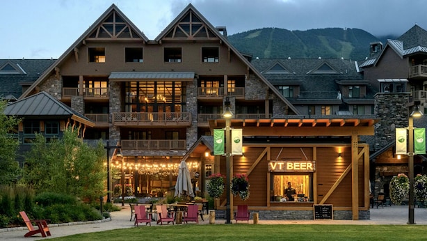 A lodge with a prominent beer tap labeled "VT BEER" and outdoor seating. - 1117 | Studio | The Mansfield | 1st floor | Private Wooded Mountain Views (Stowe)