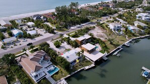 A coastal residential area with houses, a marina, and a beach. - Charming Cabana Beach Club #8 - Your Coastal retreat Awaits!#9 also available. (Longboat Key)