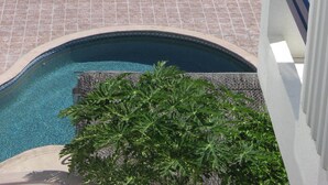 A pool area with lounge chairs and a view of the ocean. - Beachfront Condo, Summer Special, 154 u.s.  per night!!!!!!! (Beauna Vista)