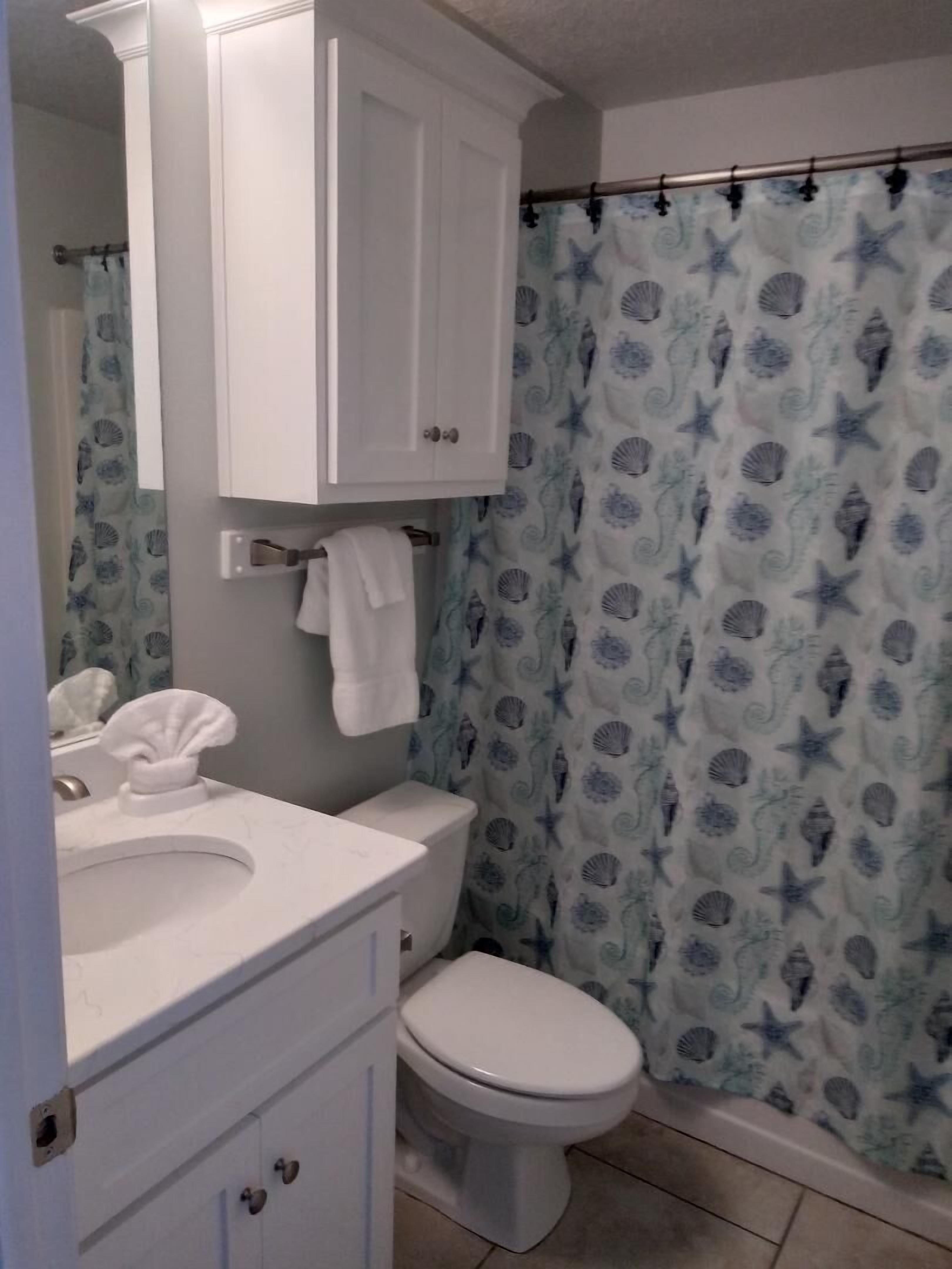 2nd full bath in hallway with shower/tub combo; across from alcove bunk beds.