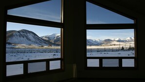 Two windows with a view of a snowy mountain landscape. - POSTCARD VIEWS-3 min TO TOWN, 5 TO SLOPES 10 ACRES 2100 SQFT  (Crested Butte)