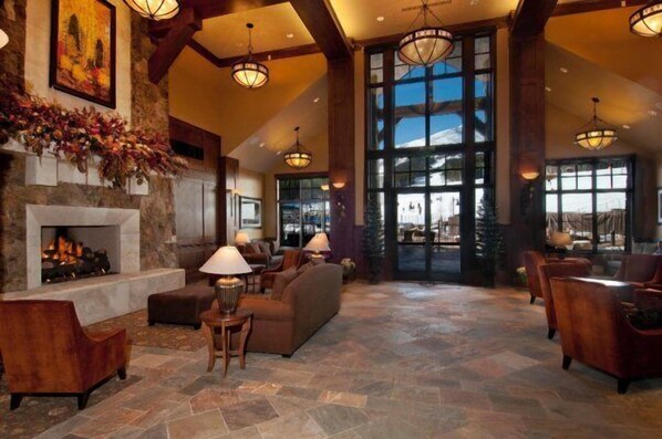 Cozy seating areas surround a warm fireplace in the spacious lobby.