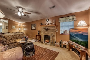 A view into the living area as you enter Cozy Creek Cabin. A new 55" Smart TV.