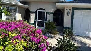 A residential house with a garage, arched windows, and a number 5131 on the wall. - Crown Pointe Home with Lake Views! (Naples)