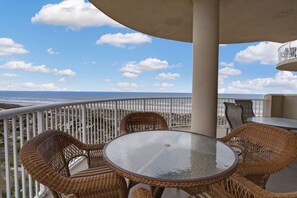 Enjoy a scenic ocean view from this balcony with a dining area.