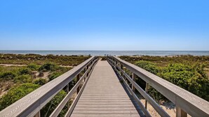 A wooden boardwalk leading to a beach with a clear blue sky. - Ocean Place Resort~incredible views and oversized balcony (Fernandina Beach)