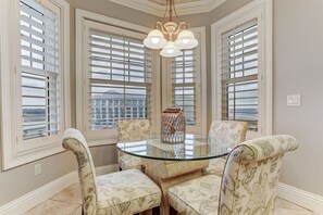 Enjoy meals in this stylish dining area with a glass-top table and comfortable seating for four.