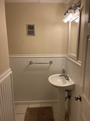 A bathroom with a white sink, a mirror, and a towel rack. - Oceanblock, steps to best beach in Bethany (Bethany Beach)