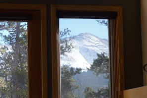 Enjoy breathtaking views of the surrounding mountains from this room's expansive window.