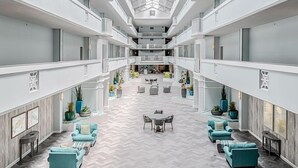 Un vaste atrium doté d’un haut plafond et d’un espace central ouvert aménagé avec des sièges.