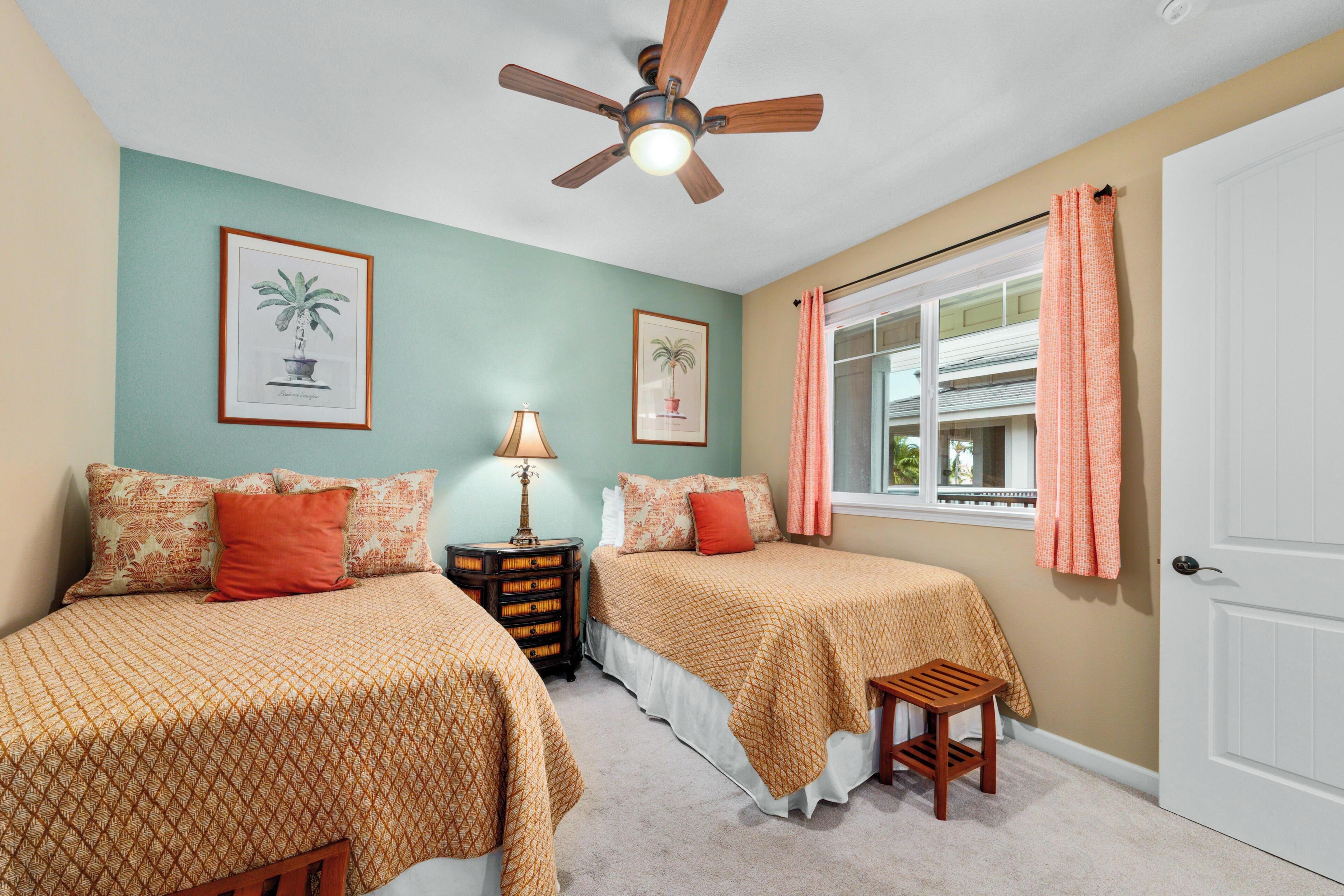 A bedroom with two beds, a ceiling fan, a window with curtains, and framed plant illustrations on the wall.