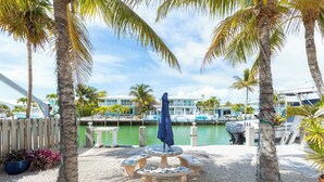 A marina with boats, a pool, and a gazebo. - Lazy Tortuga ground level 2bed/2bath half duplex with dockage & cabana club (Key Colony)