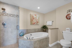 A bathroom with a glass-enclosed shower, a freestanding bathtub, a toilet, and a potted plant. - Beautiful Beachfront Property!2 Bdrm/2 Ba, Cov. Parking, Unit 802 (Destin)