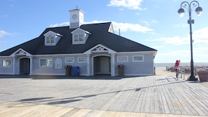 A public restroom building with a clock tower, located on a wooden boardwalk by the beach. - Amazing Location! PRIME location on Wesley.  Includes Tags/Chairs/Umbrellas!  (Ocean City)