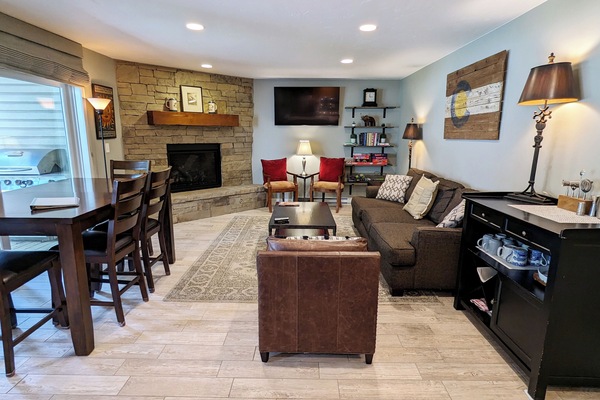 BC West Condo V-1 living room with gas fireplace and patio with propane BBQ