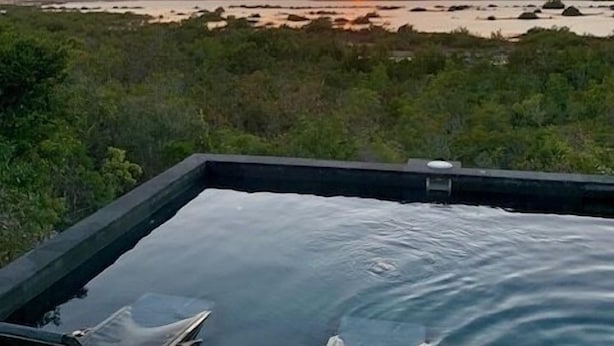 A pool with two lounge chairs facing a sunset over a natural landscape. - Escape to Westview Gardens, 3 bedroom home with private pool & sunset views. (Long Bay Hills)