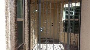 A gated entrance with a number '2524' above it, a metal gate, and a door with a handle. - North Central Phoenix - Two Master Stes. 1500 Sf Newly Remodeled, Peaceful!! (Phoenix)