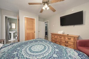 A bedroom with a bed, a dresser, a television, and a ceiling fan. - Spacious 11BR Cabin for Groups | Near Granby Ranch (Granby)