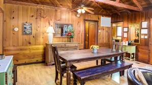 A wooden interior with a dining table, benches, and a ceiling fan. - (50R) Soots - Me at The Redwoods In Yosemite (Yosemite National Park)