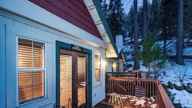 A building with a sign reading 'Spring Wonderland,' a wooden deck, and a snow-covered landscape. - Inside Yosemite Park-Yosemite Spring Wonderland (Yosemite National Park)