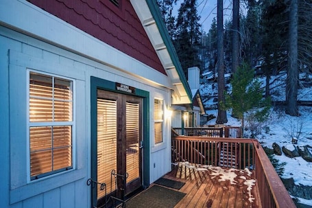 A building with a sign reading 'Spring Wonderland,' a wooden deck, and a snow-covered landscape.