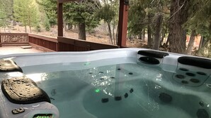 A hot tub with control panels and a wooden deck. - Winter wonderland perfect for multiple families- 3 master bedrooms! (Truckee)