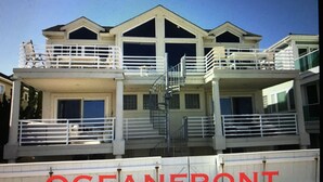 A multi-story building with balconies and a staircase. - Oceanfront 12 Bedroom 8 Bath in Ocean City, New Jersey (Ocean City)