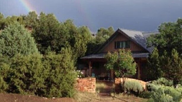 A house with a sloped roof, surrounded by dense greenery. - Unsurpassed Night Skies And Fresh Mountain Air In A Traditional Village (Santa Fe)