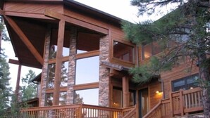 A multi-level wooden cabin with stone accents, featuring a balcony and a staircase. - Spectacular Torreon Mountain Estate (Show Low)