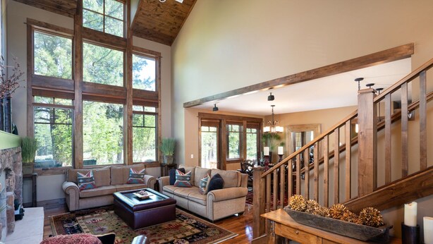 A spacious living room with a large sofa, a coffee table, and a wooden staircase. - Dog-Friendly Villa, Steps Away From Old Greenwood's Driving Range! (Truckee)