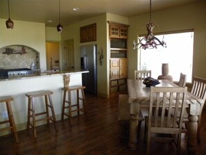 Enjoy a casual dining experience in this well-equipped kitchen with a central island and adjacent dining area.