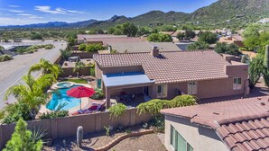 A residential area with a swimming pool, patio furniture, and a view of the surrounding landscape. - Pool and Spa (Private) - Tucson Arizona Home (Tucson)