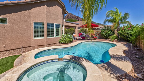A house with a swimming pool, a patio with chairs, and a mountain in the background. - Pool and Spa (Private) - Tucson Arizona Home (Tucson)