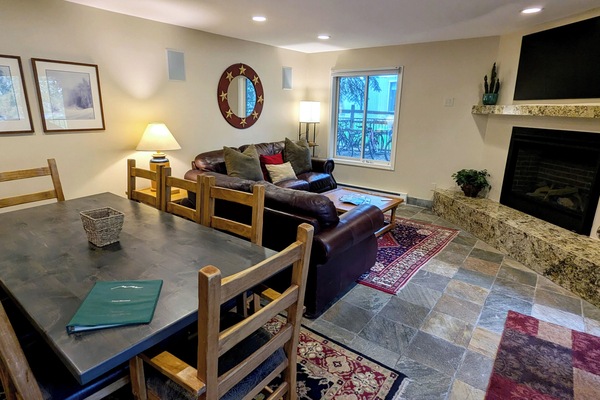 BC West Condo W-1 Living room with sofa bed, gas fireplace, and dining table