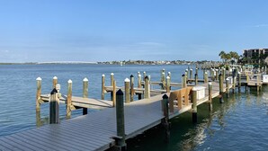 A wooden pier extending into calm water, with a clear sky above. - Water View of Marco Pass, Heated Pool & Marina-Newly Updated 5th Floor 1Br/1Ba (Marco Island)