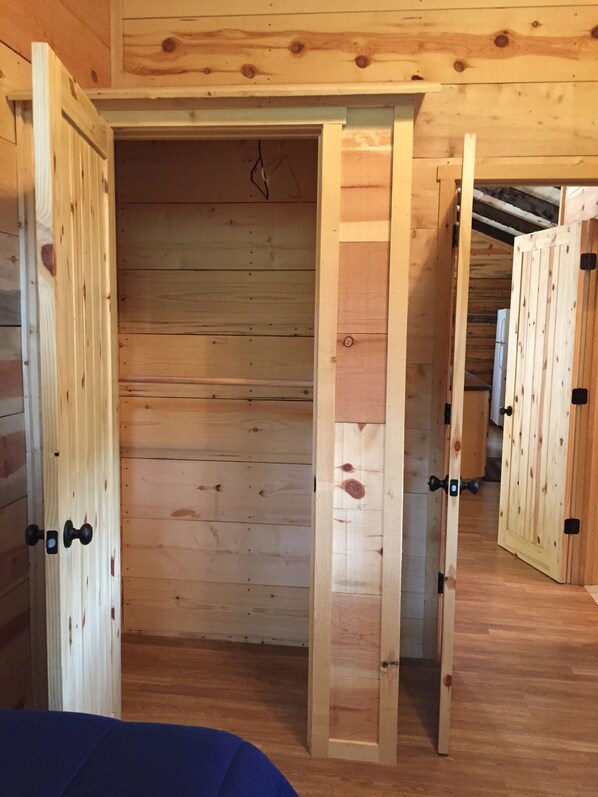 A wooden interior with a sliding door leading to a hallway.