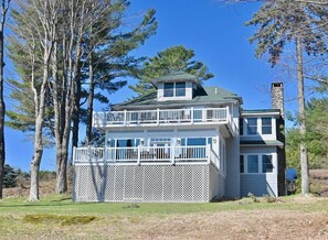 A two-story house with a balcony, surrounded by trees. - Veranda 5 Bedroom Unit 2 (Lake Placid)